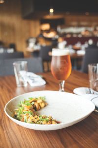 A plate of food sitting next to a pint of Surly beer in the Minneapolis brewery's Brewer's Table restaurant.