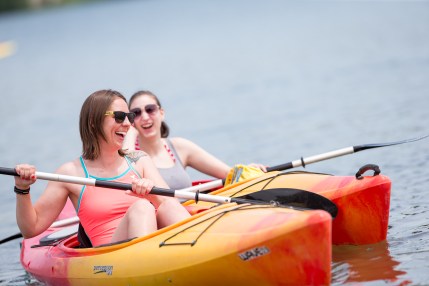 Two women paddle in Wheel Fun Rentals kayaks.