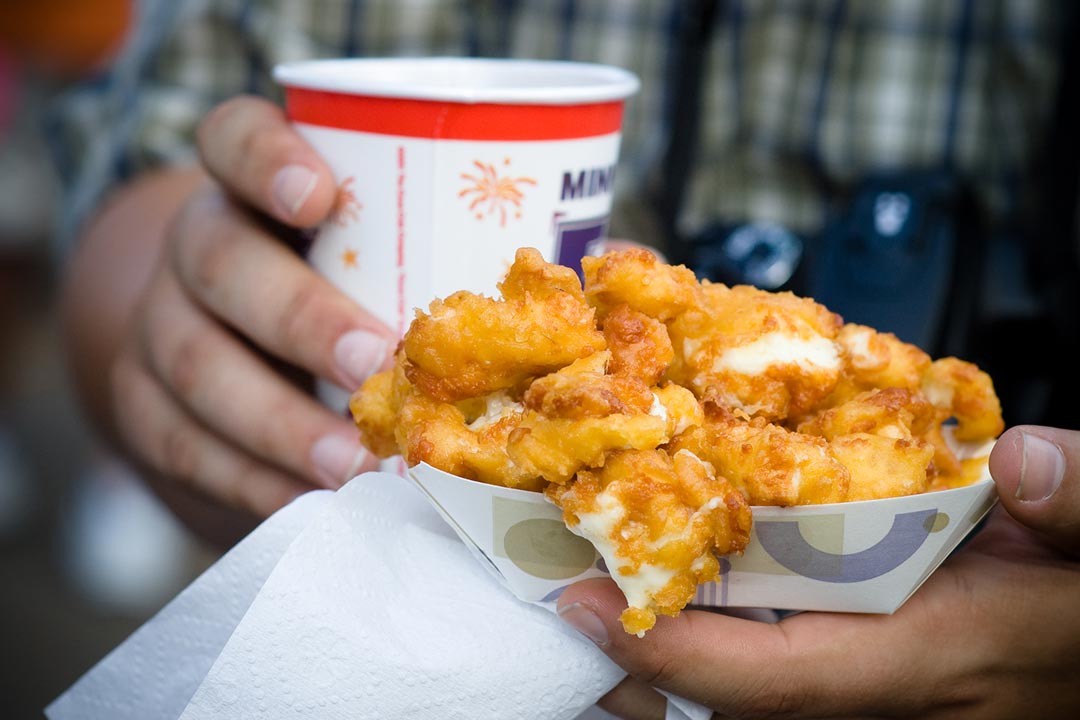 A person holding cheese curds at the Minnesota State Fair.