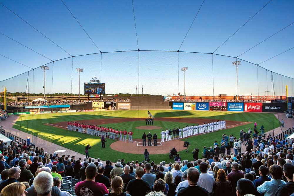 Players and the crowd standing for the National Anthem before a Saints game at CHS Field, which is one of the stops on the Metro Transit Green Line.