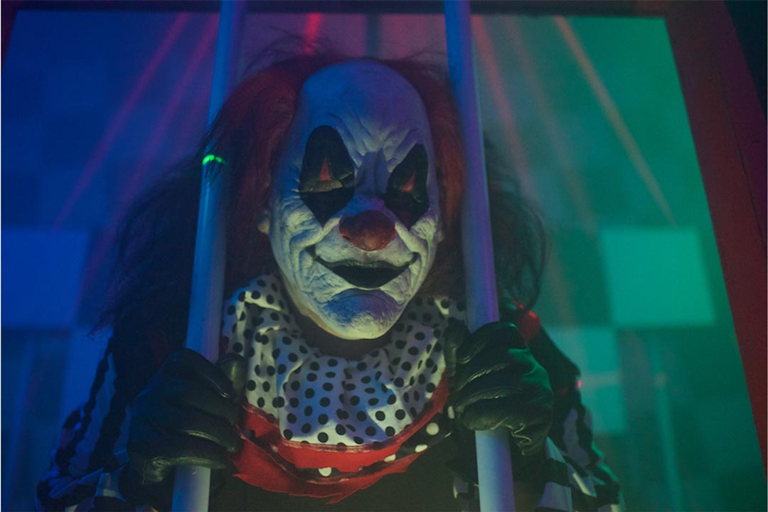 A clown behind jail bars at the Dead End Hayride, one of the many haunted houses in the Twin Cities.