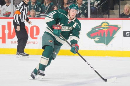 Zach Parise skating with the puck during a Wild hockey game.