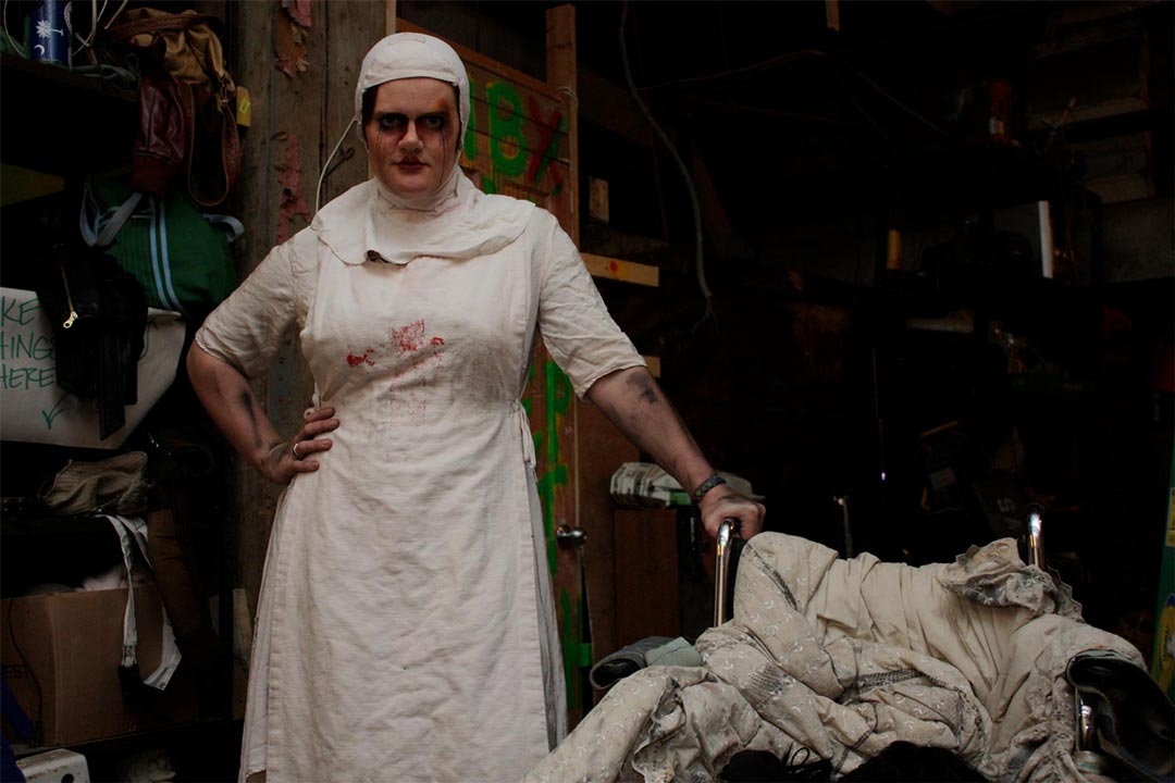 A nurse holding a wheelchair full of rags at the Haunted Basement, one of the many haunted houses in the Twin Cities.