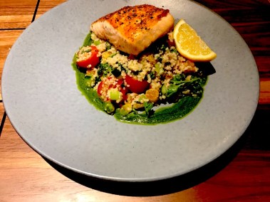 Plancha-cooked salmon on a bed of tabbouleh salad.