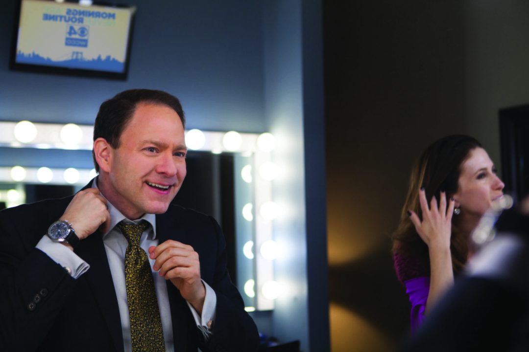 Photo by Kelly A. Pederson. Jason DeRusha makes sure everything is in place before going on air.