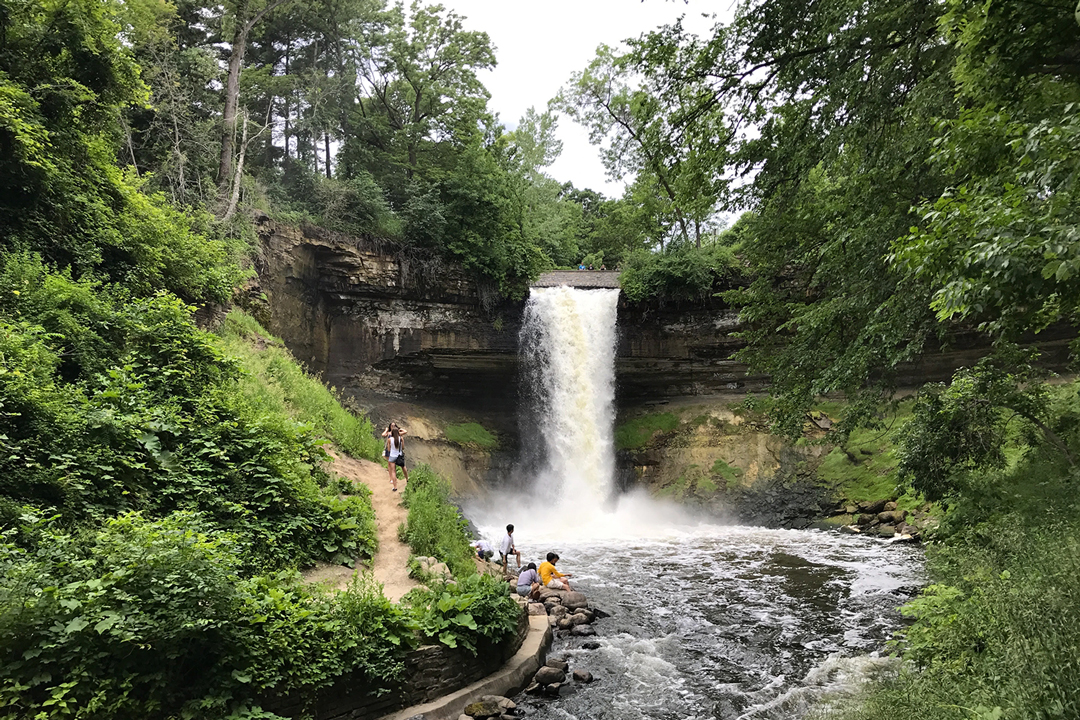 People visiting Minnehaha Falls at Minnehaha Regional Park in Minneapolis, Minnesota.