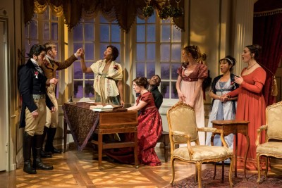 Photo by Dan Norman, courtesy of Jungle Theater. The Bennets and spouses gather round the piano as Mary plays.