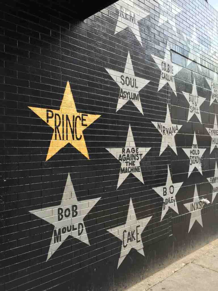 Photo by Kristen Montag, courtesy of Meet Minneapolis. Prince's golden-leafed star stands out on First Avenue's famous painted wall.